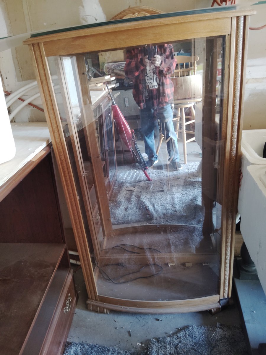 Wooden display cabinet with glass front slightly dusty